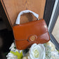 Tory Burch Robinson small brown top handle bag front view
