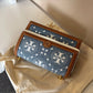 Tory Burch T Monogram denim shoulder bag in blue and brown detail