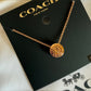 Coach 54514 rose gold disc pendant necklace detail