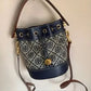 Tory Burch blue and brown mini bucket bag detail