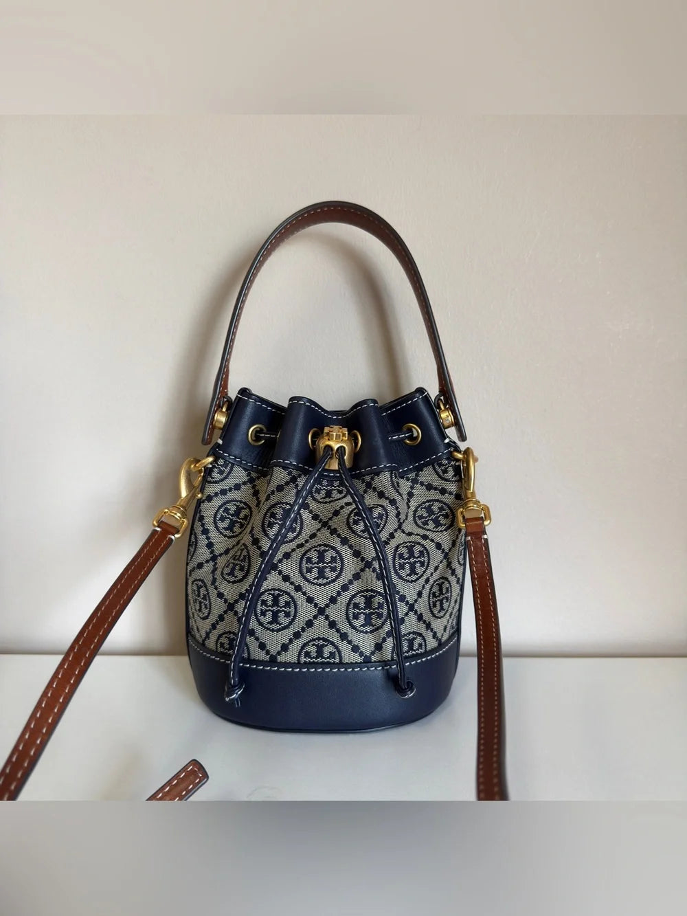Tory Burch blue and brown mini bucket bag detail