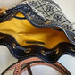 Tory Burch blue and brown mini bucket bag detail